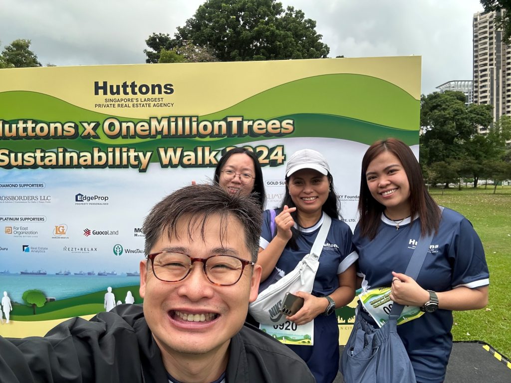 Staff standing in front of Banner for OneMillionTrees Walk