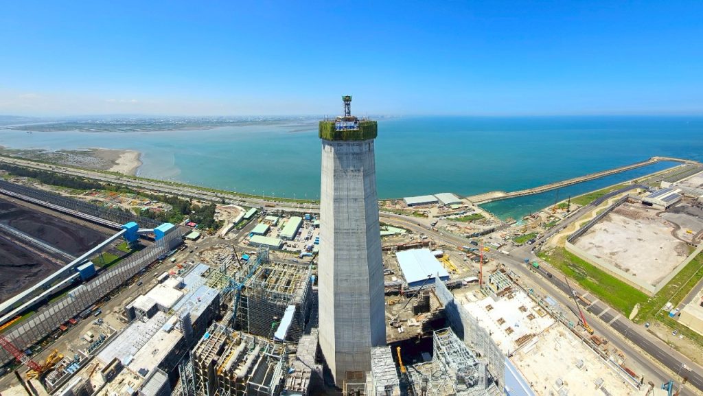 Slipform slide completed on 150-meter reinforced concrete chimney at Taichung Power Plant.